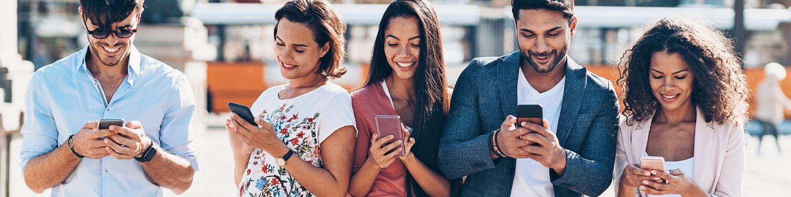 Men and women leaders on their cellphones connecting with Dr. Kevin John on social media.