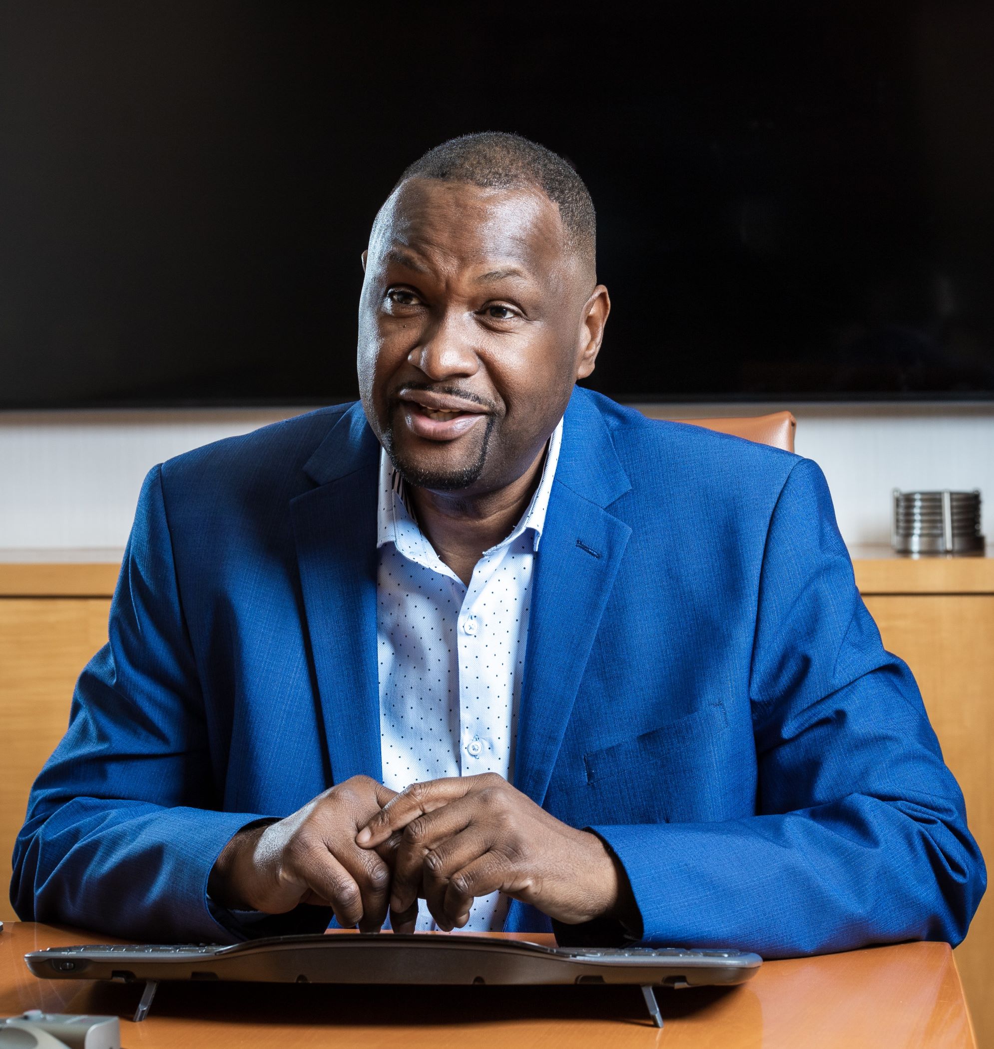 Dr. Kevin John in the office coaching a group of leaders. 