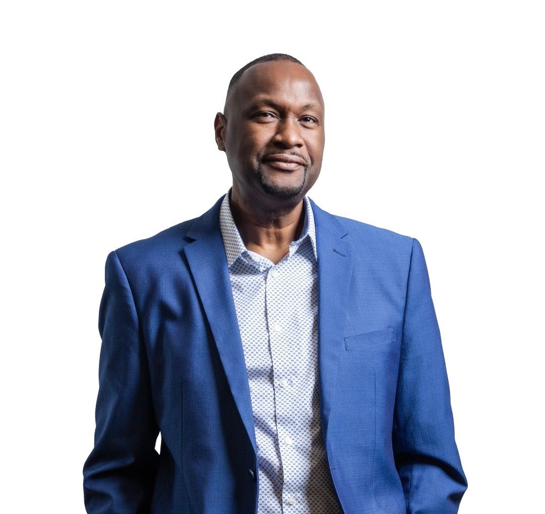 Dr. Kevin John standing and smiling.